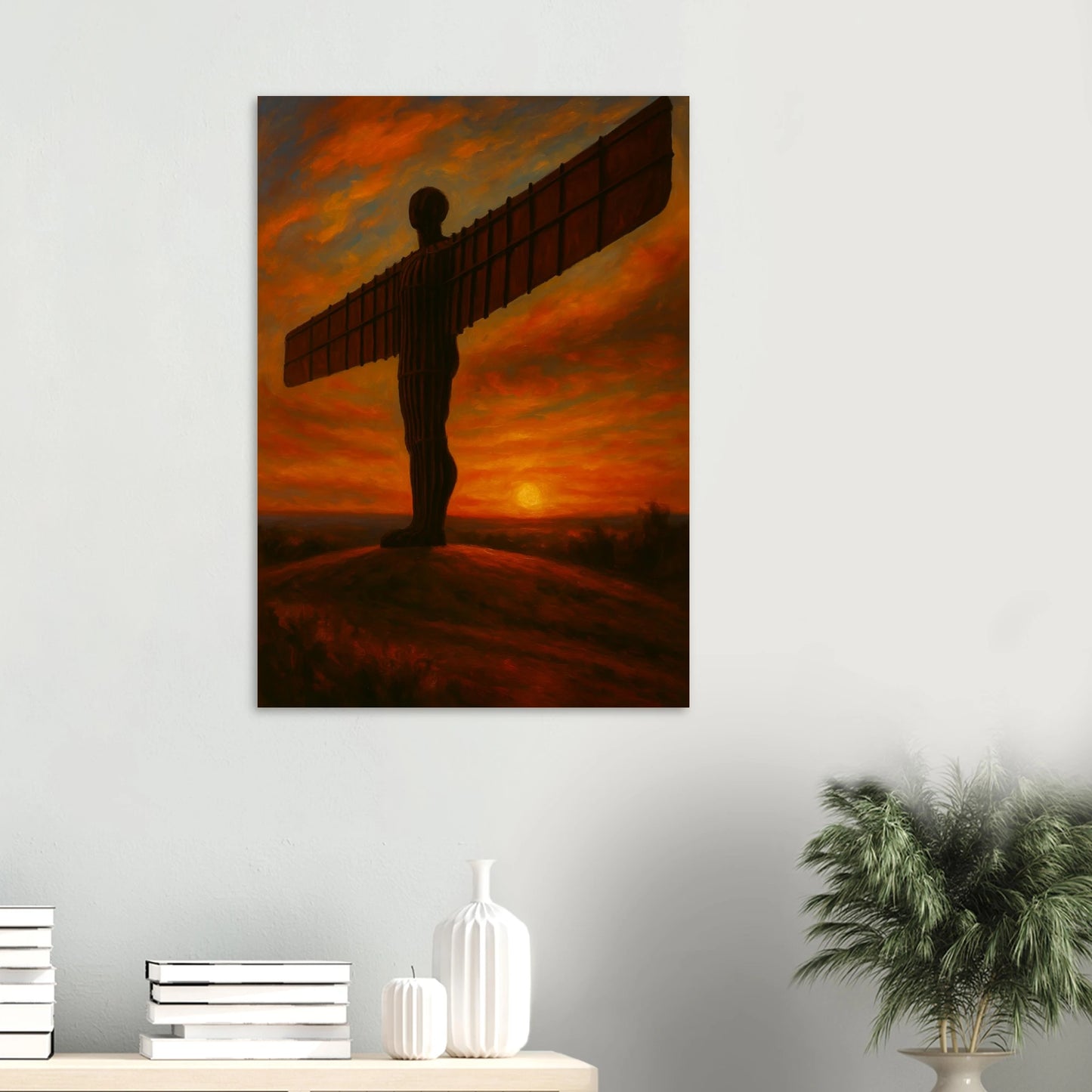Silhouette of an angel against a sunset sky on a wall above a shelf with decorative items.