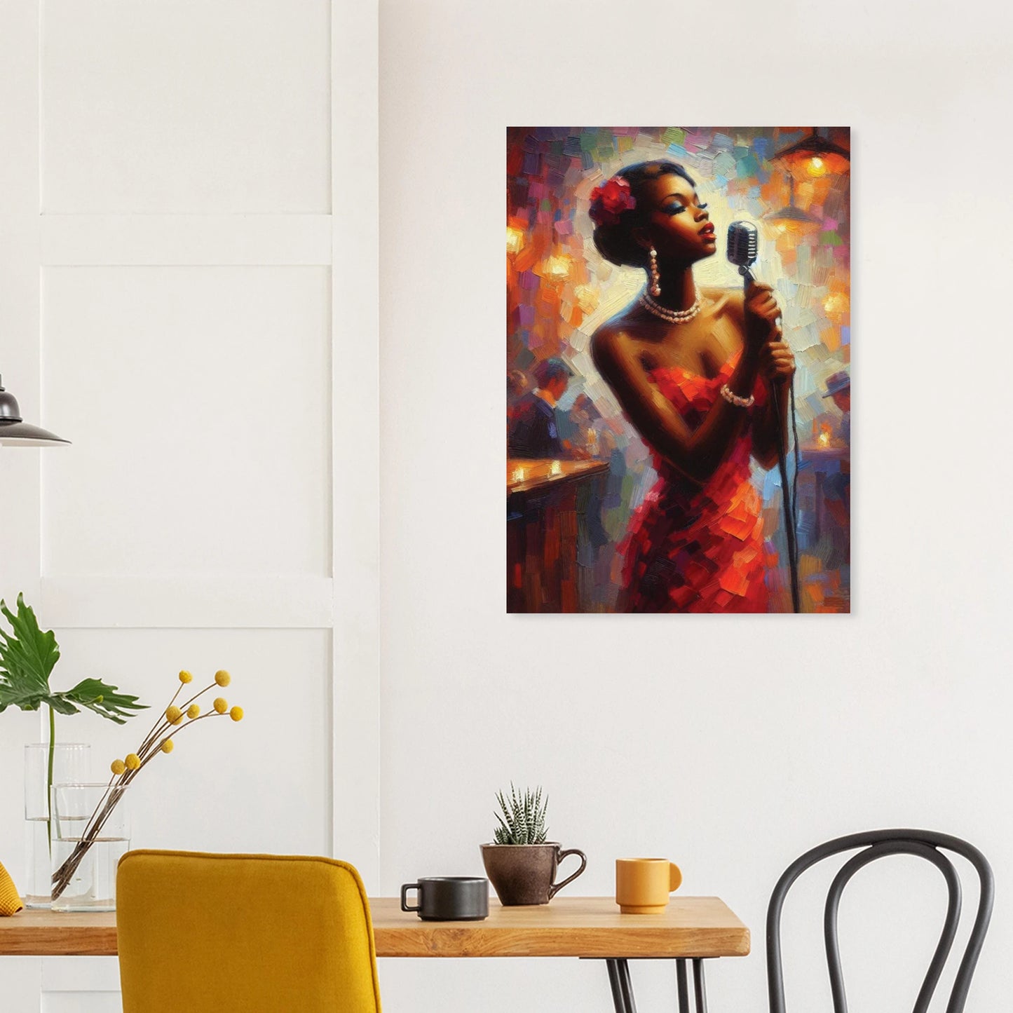 Wall art print of a woman holding a microphone on a wall above a table with chairs.